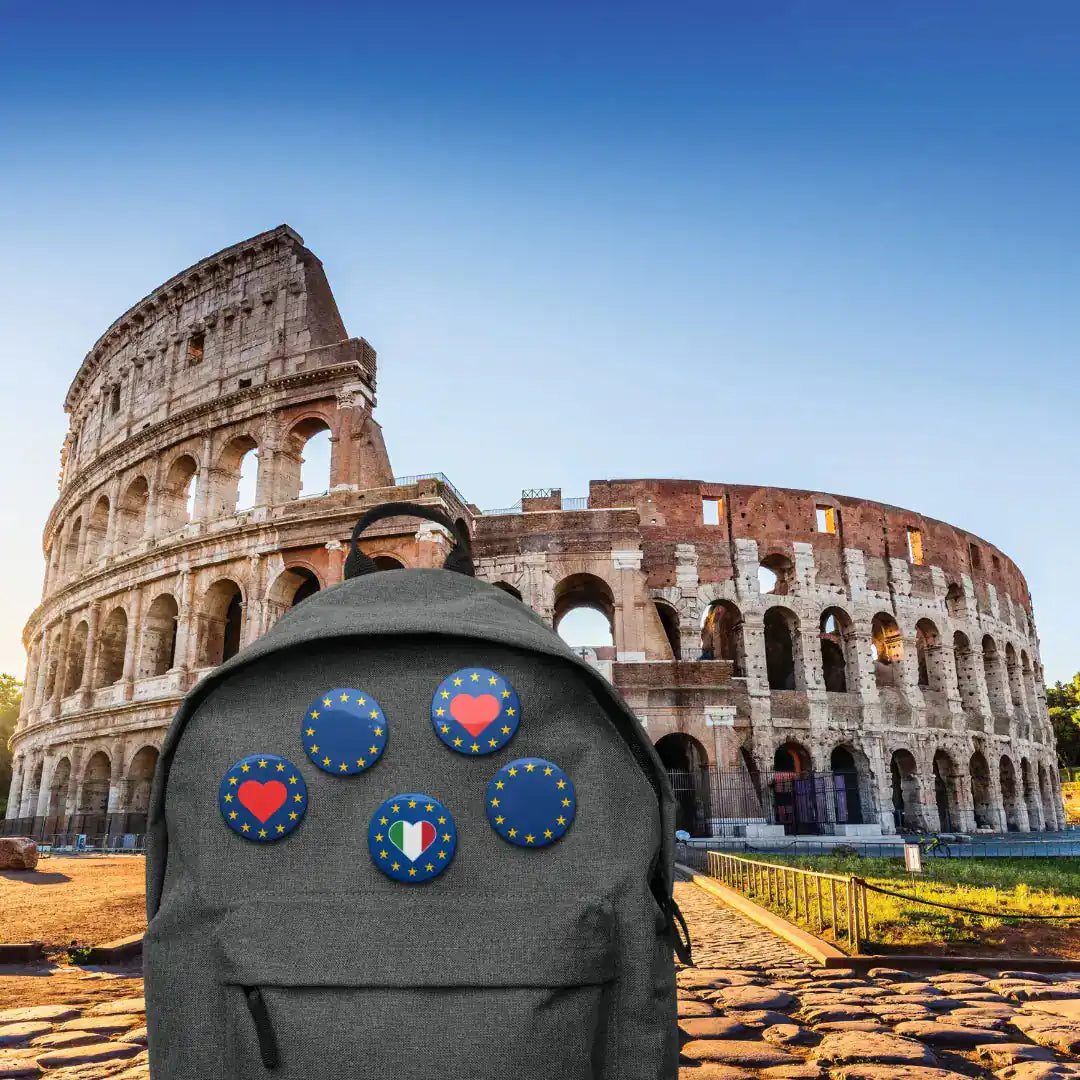 Backpack with "Show the Love for Europe" pins in front of Colosseum, Rome