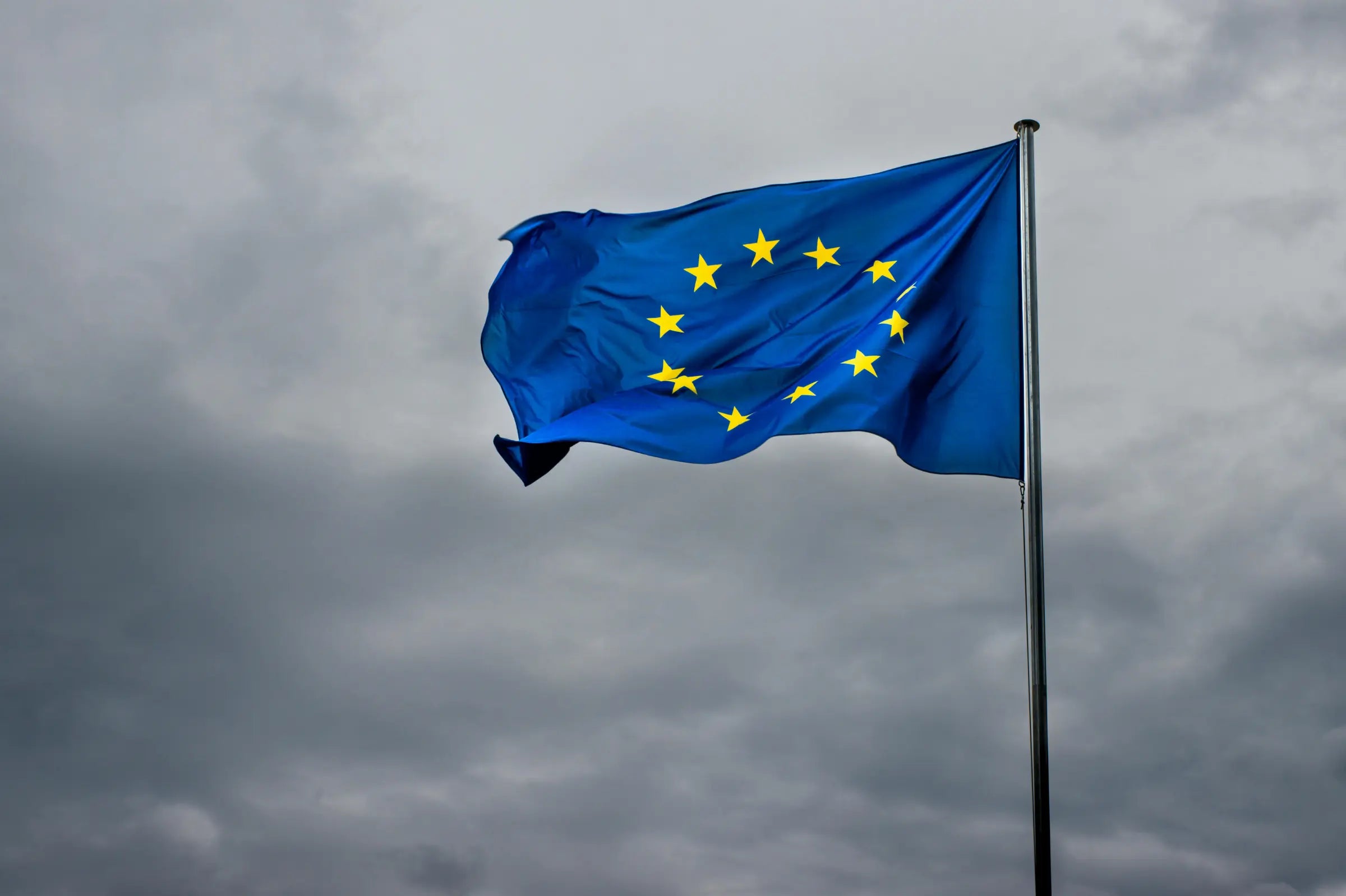 European Union flag waving against a cloudy sky